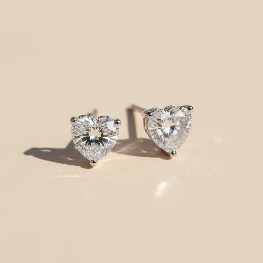 Heart-shaped 1ct lab diamond moissanite stud earrings on beige background