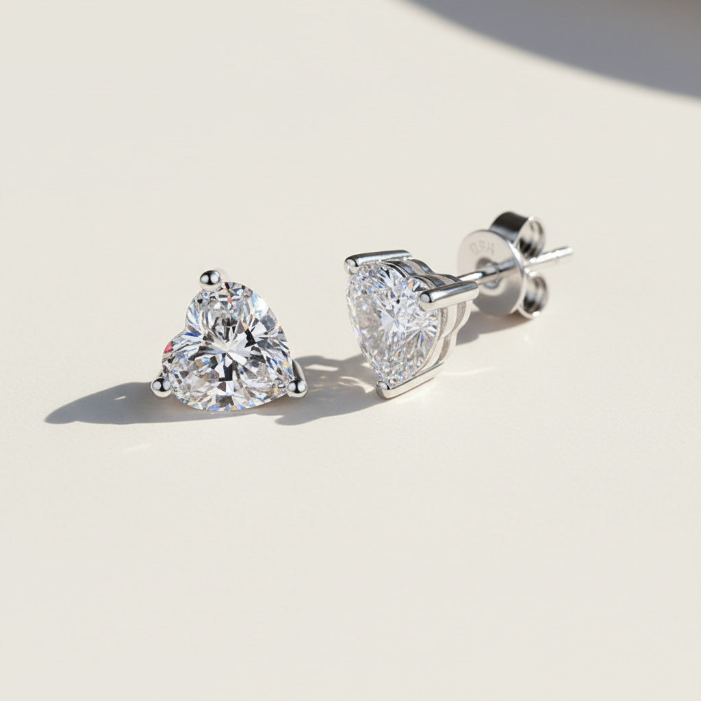 Close-up of platinum-plated heart-cut moissanite studs with butterfly backs
