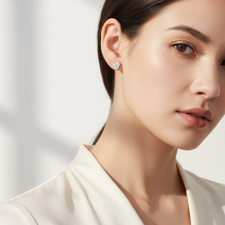 Model wearing heart-shaped lab diamond moissanite stud earrings