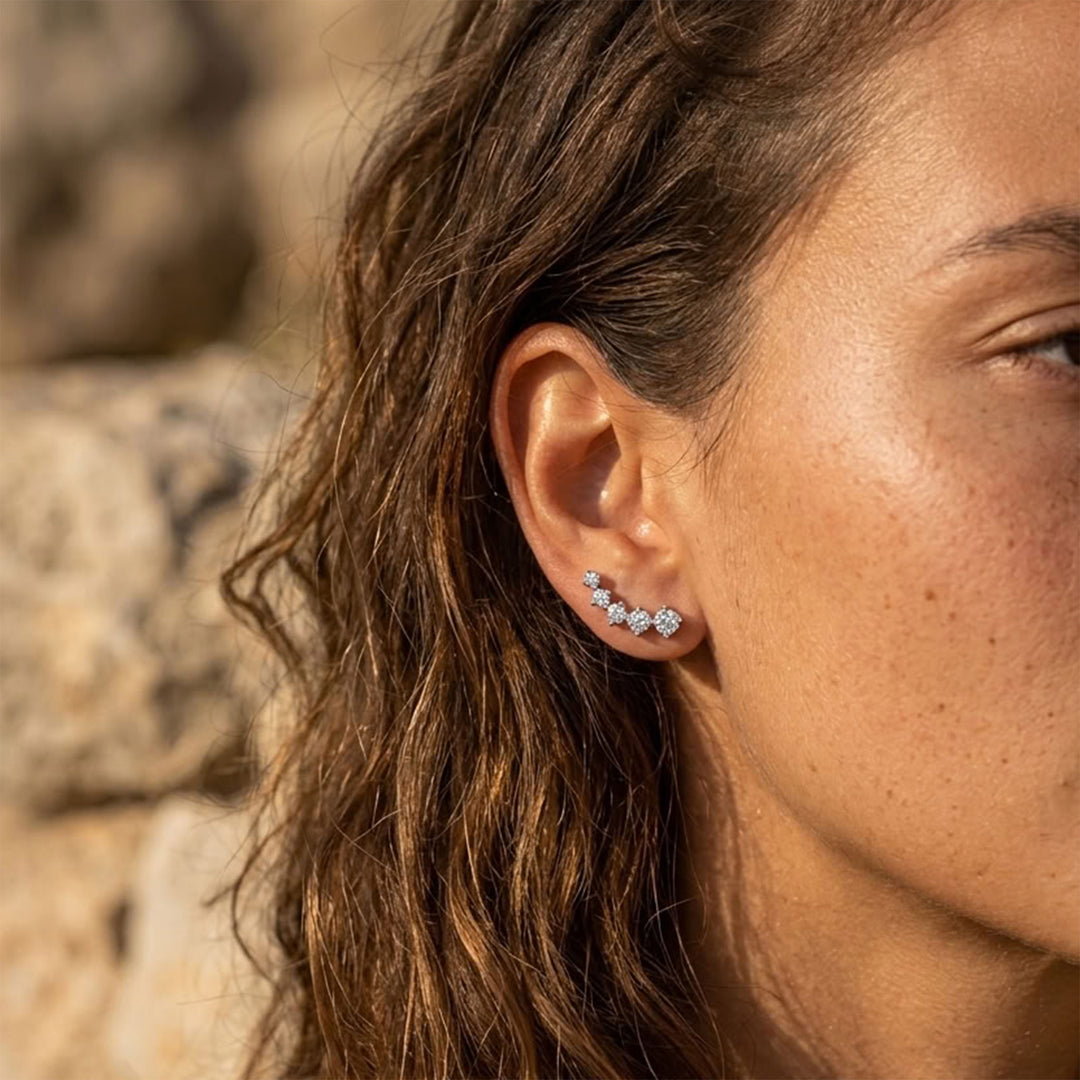 Moissanite ear climber earring worn along the earlobe in natural sunlight