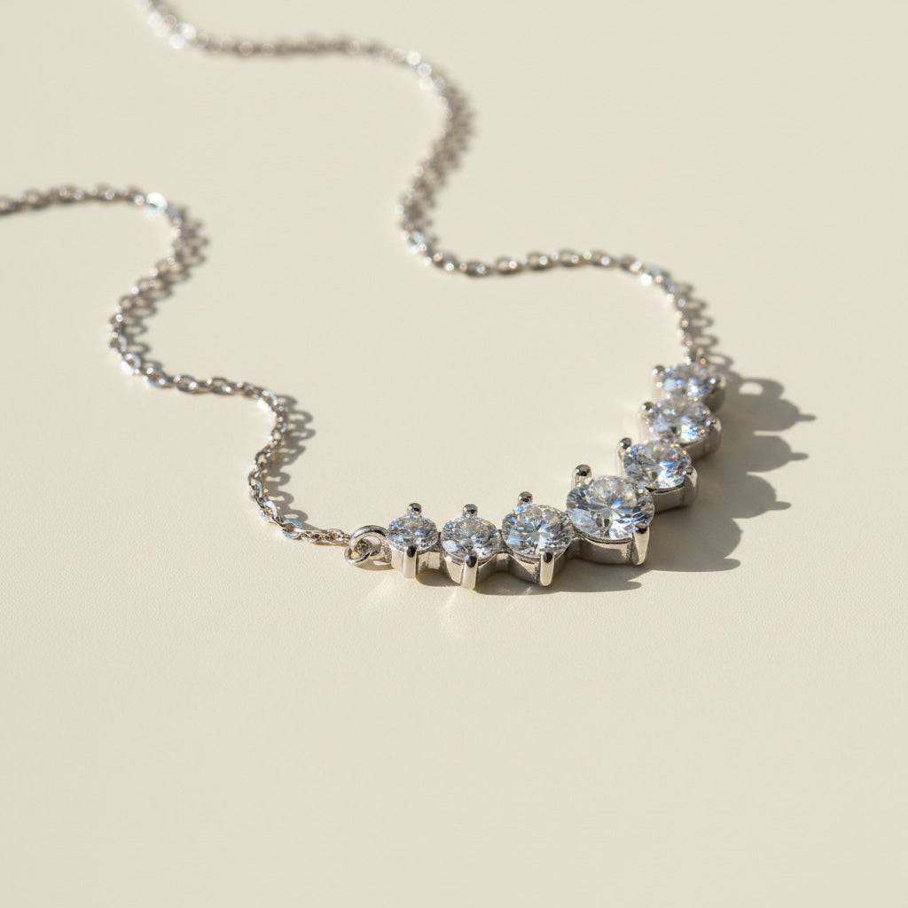 Silver necklace with moissanite stones on a beige background