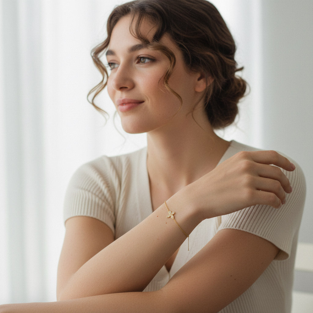 Woman styling a gold-plated moissanite butterfly bracelet in natural light