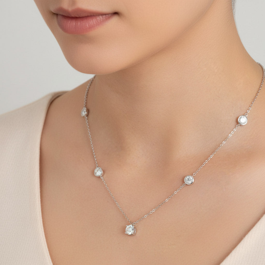 Model wearing Platinum-plated moissanite necklace with 1ct center stone and 5mm side stones