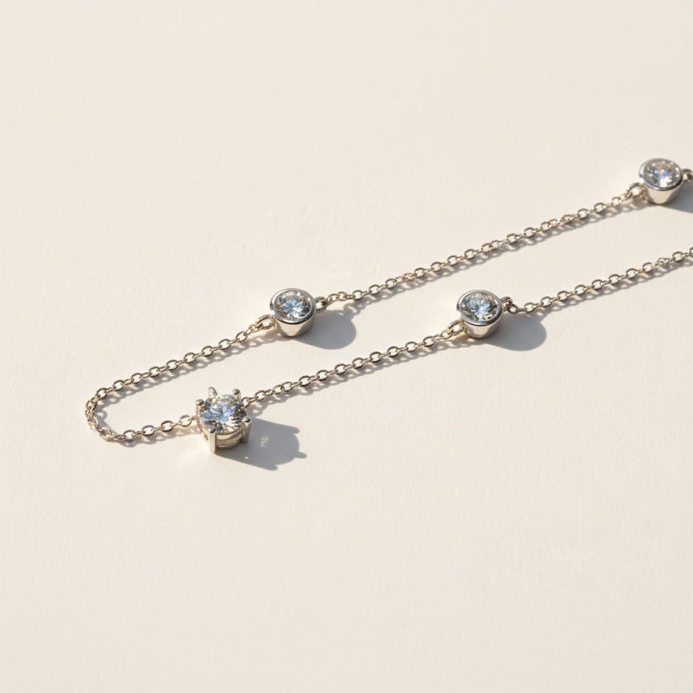 Close-up of moissanite pendant with 6.5mm and 5mm stones on silver chain
