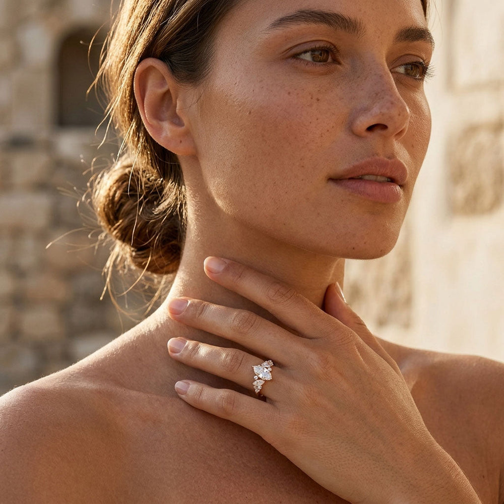Woman wearing a moissanite diamond ring outdoors with a stone wall background