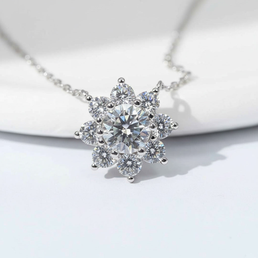 Close-up of floral halo pendant with 1ct center moissanite and halo stones on platinum plated sterling silver.