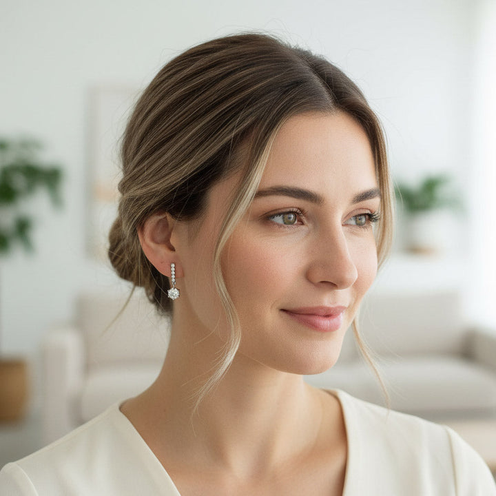 Woman wearing platinum S925 moissanite drop earrings with 1ct center stones