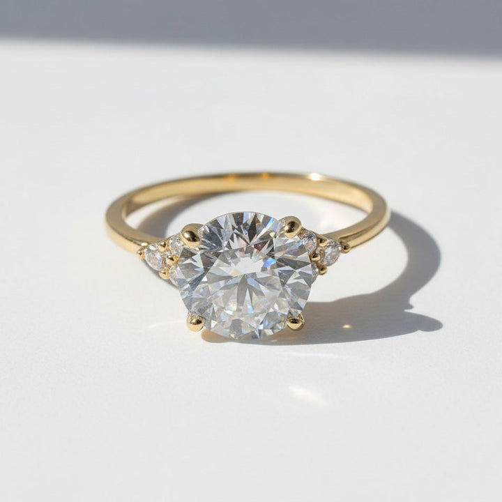Gold 3ct round brilliant lab grown moissanite ring on white background