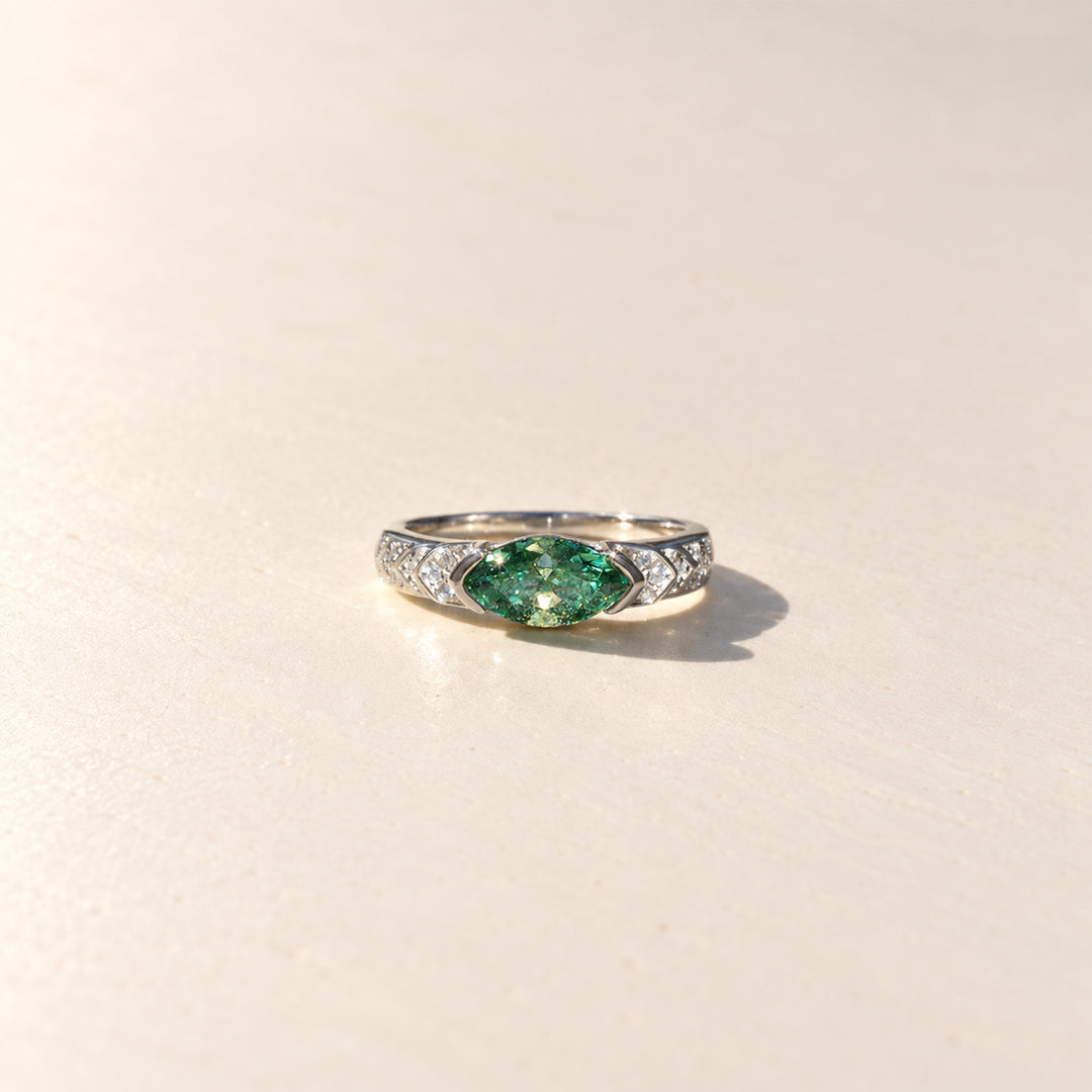 Front view of 1 carat green marquise Guardian Eye moissanite ring with white moissanite side stones in platinum-plated sterling silver