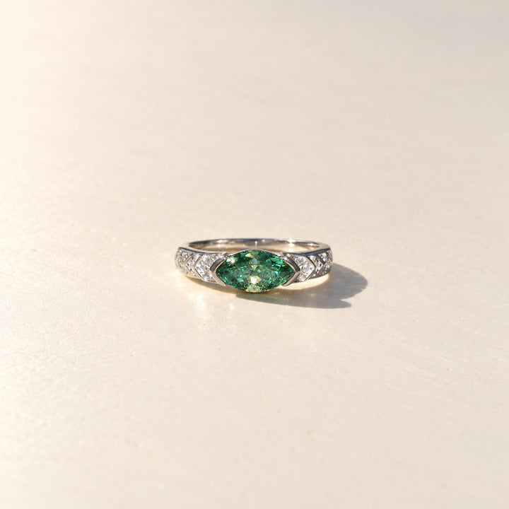 Front view of 1 carat green marquise Guardian Eye moissanite ring with white moissanite side stones in platinum-plated sterling silver