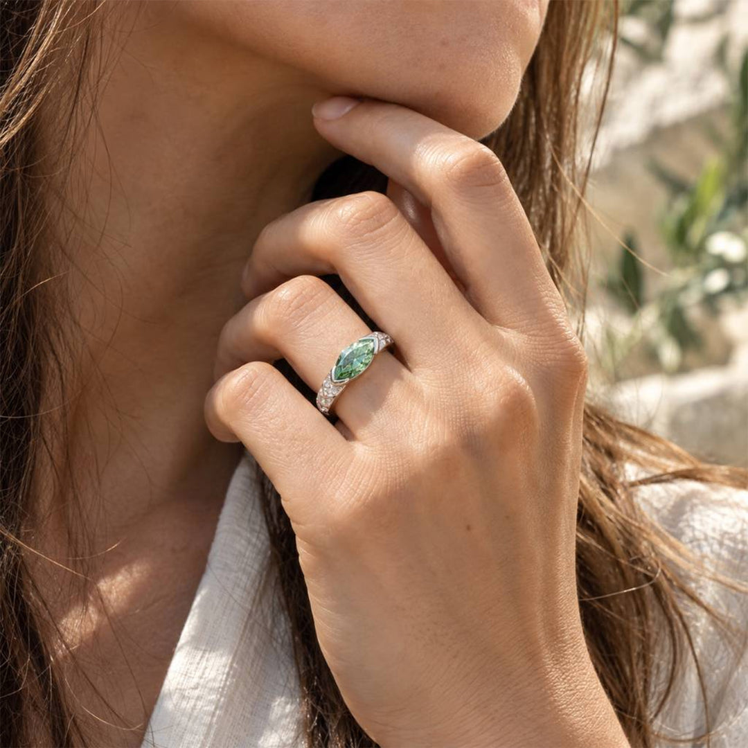 1 carat green marquise moissanite ring worn on hand in natural sunlight