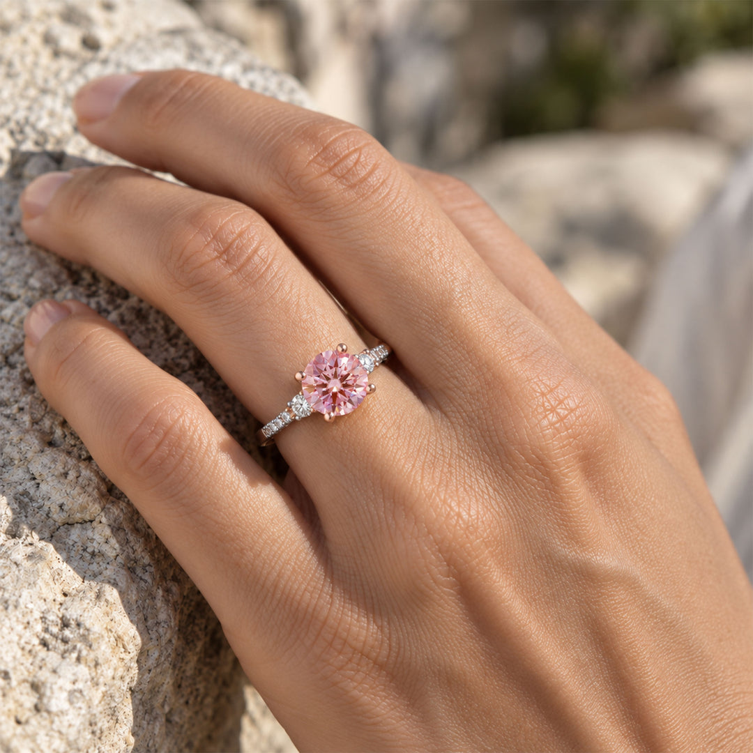2 carat pink moissanite two-tone ring worn on hand in natural sunlight