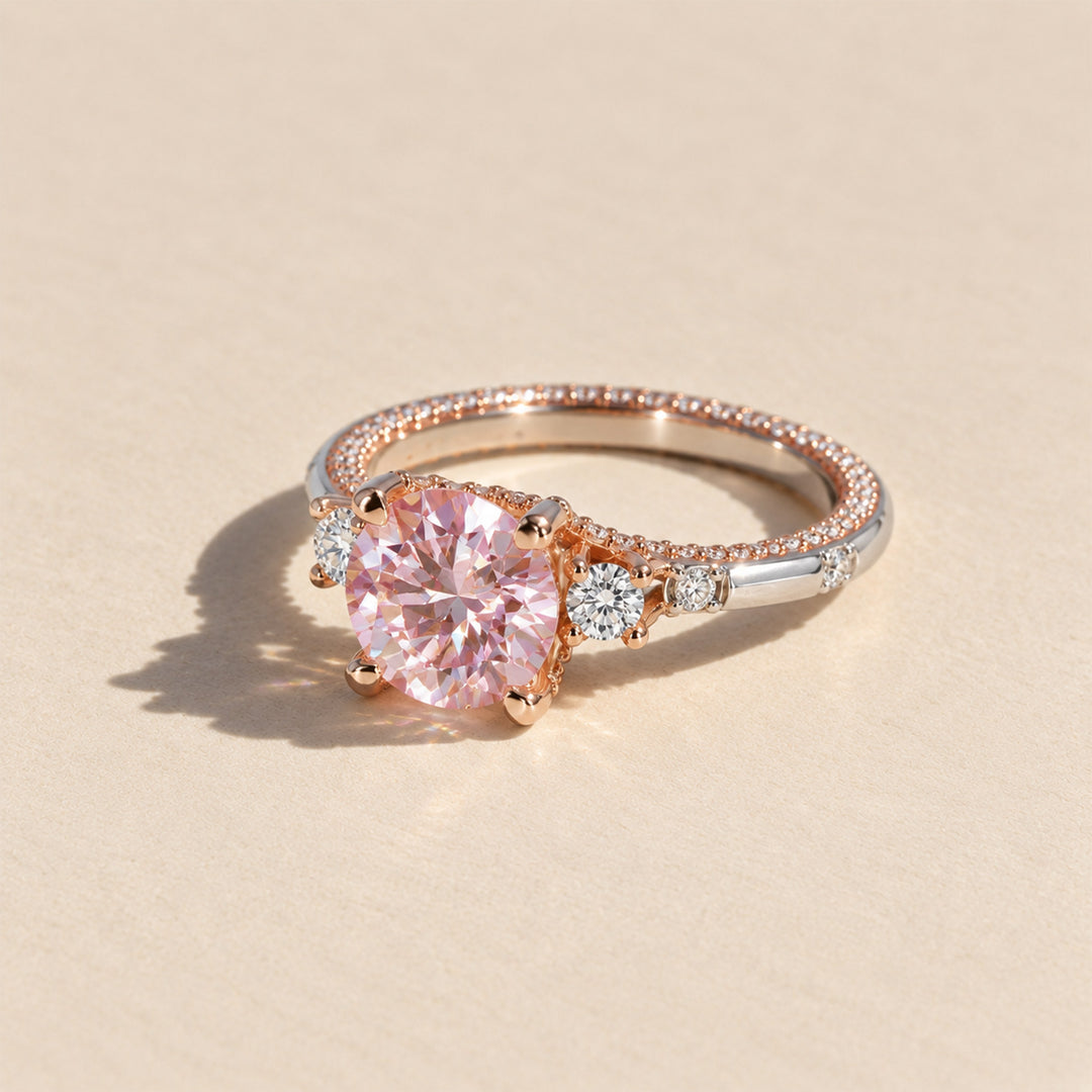 Side view of 2 carat pink moissanite two-tone ring with white moissanite side stones and pavé band