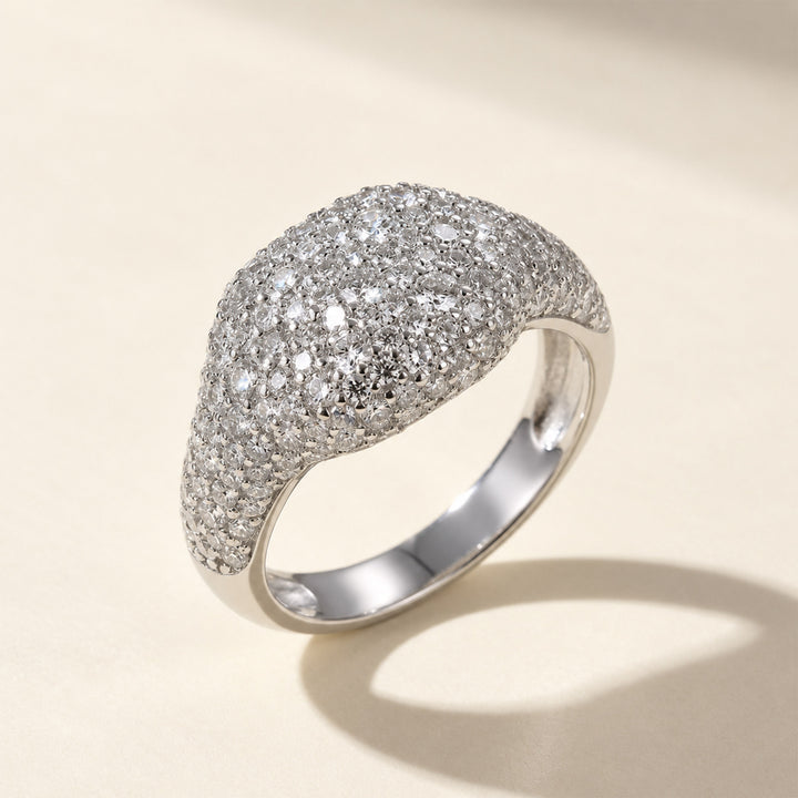 Close-up side view of wide pavé moissanite dome ring in sterling silver