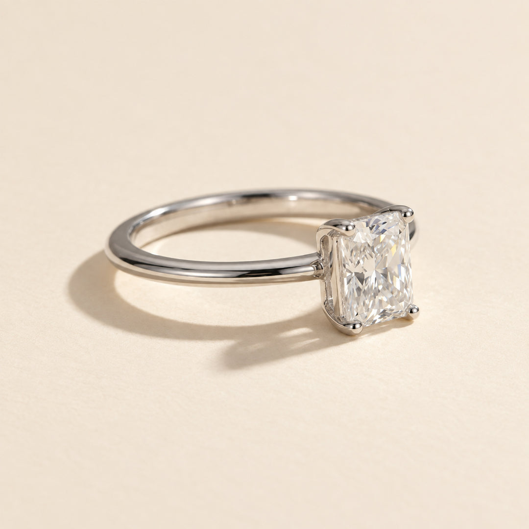 Three-quarter view of radiant-cut VVS1 moissanite ring with four-prong setting