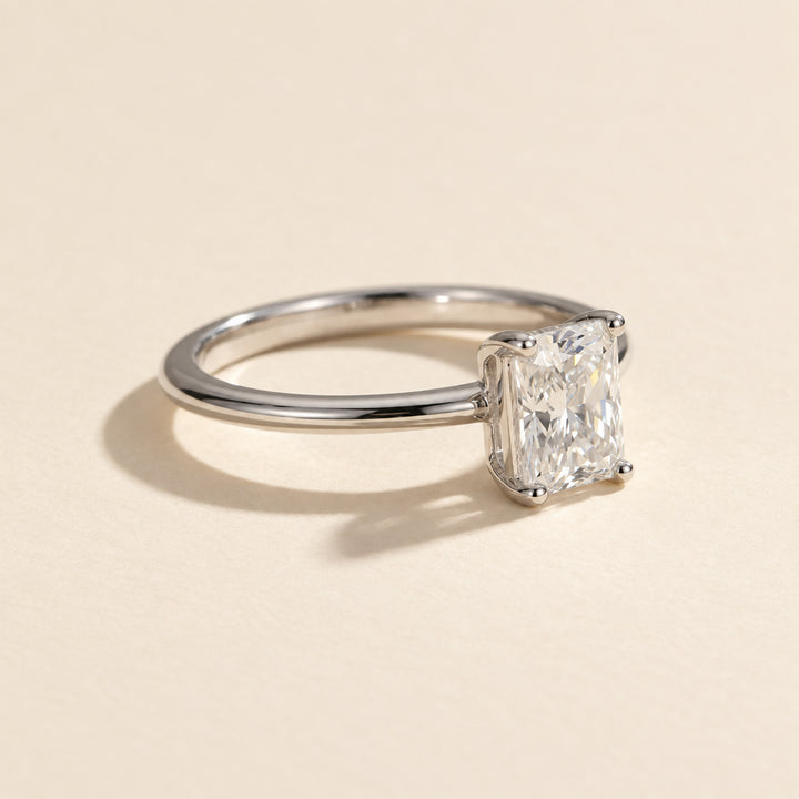 Three-quarter view of radiant-cut VVS1 moissanite ring with four-prong setting