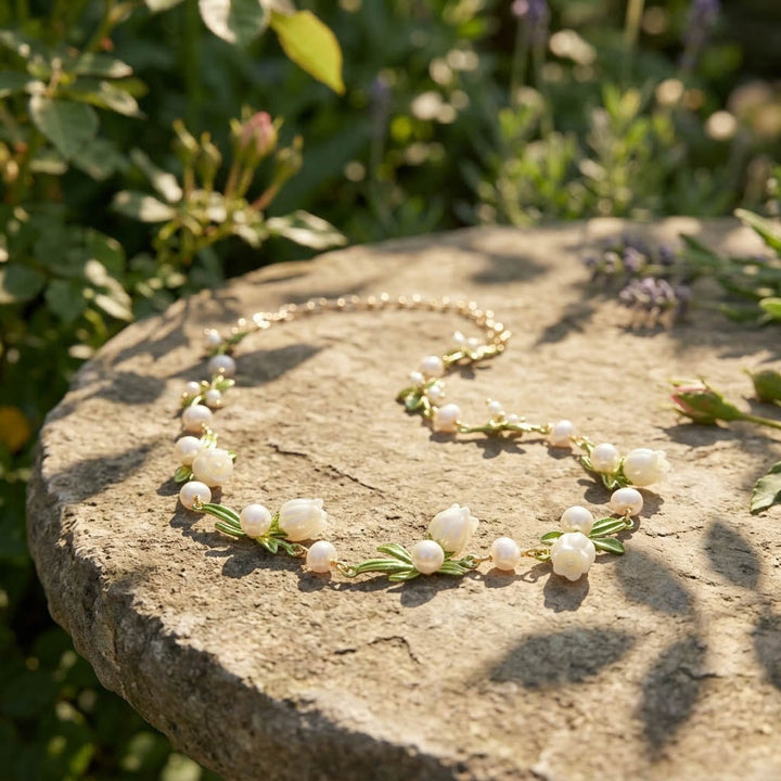 Lily of the valley necklace with mother of pearl flowers and freshwater pearls in gold plated brass on stock background
