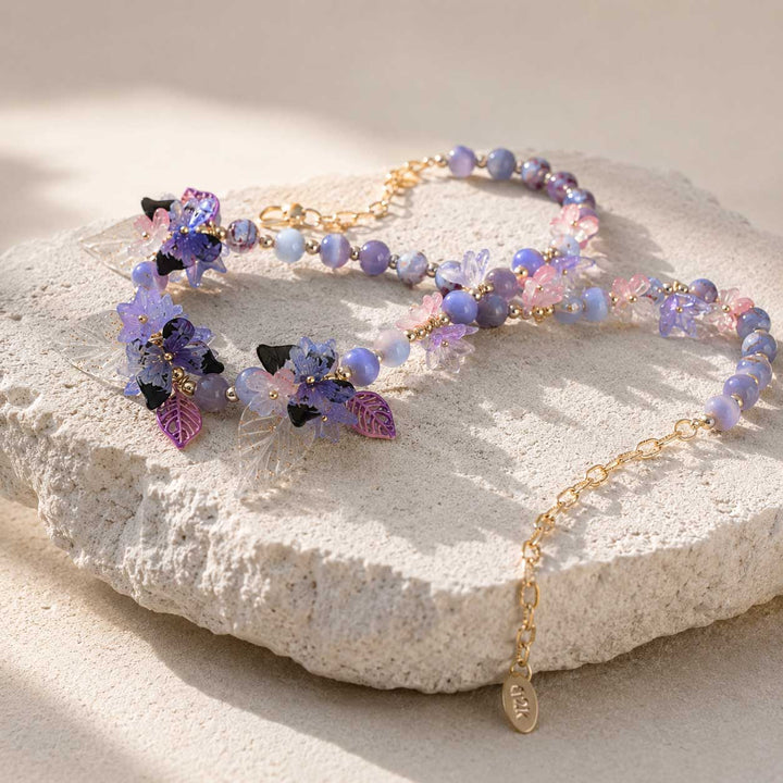 Butterfly Bloom Garden Necklace Displayed on Natural Stone Surface with Floral Details