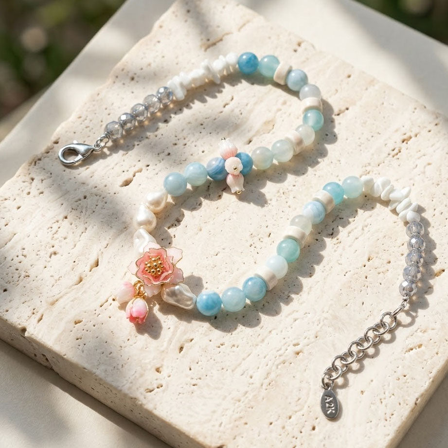 Lotus Amazonite Necklace with Hand-Painted Lotus Flower on a textured surface