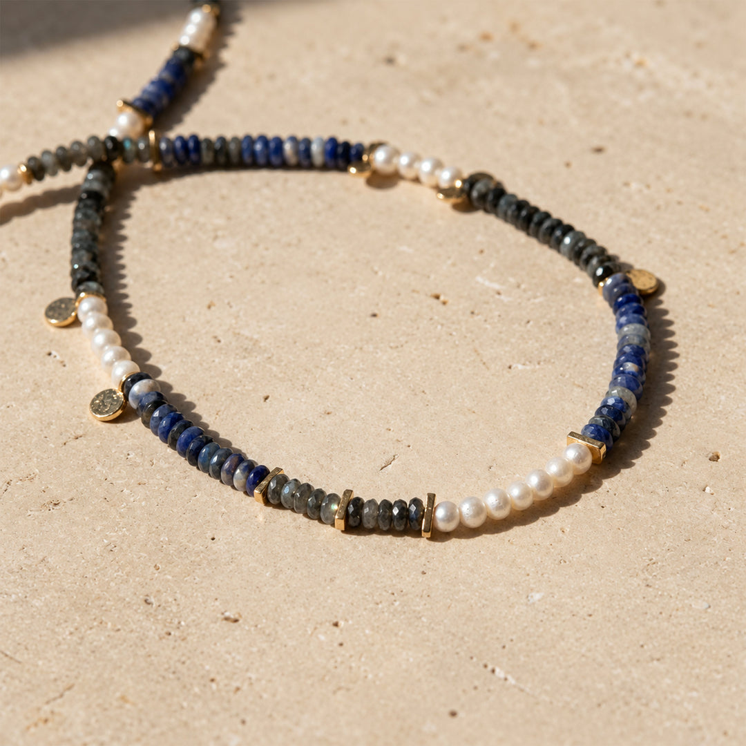 Close-up of Black Labradorite, Sodalite and freshwater pearl beads with small gold spacer details