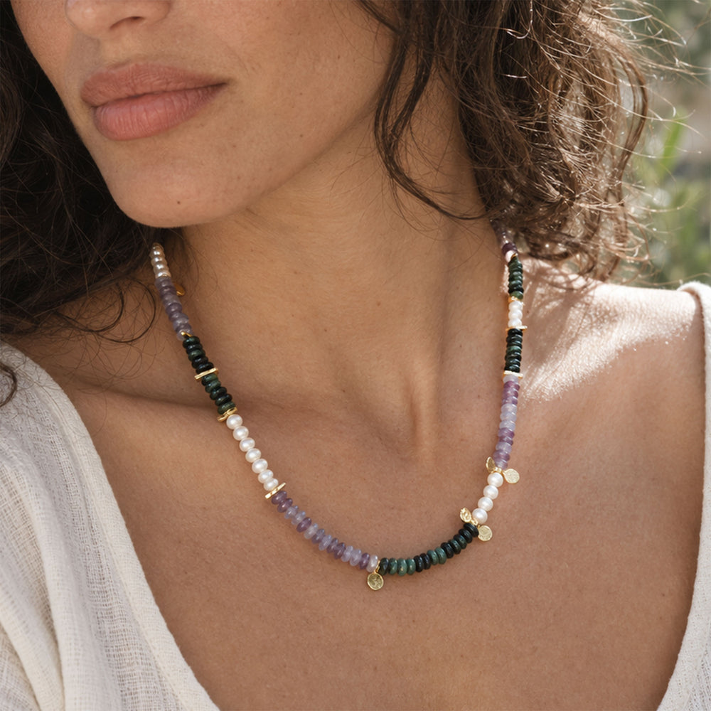 Model wearing amethyst and Kambaba Jasper pearl necklace with delicate gold details