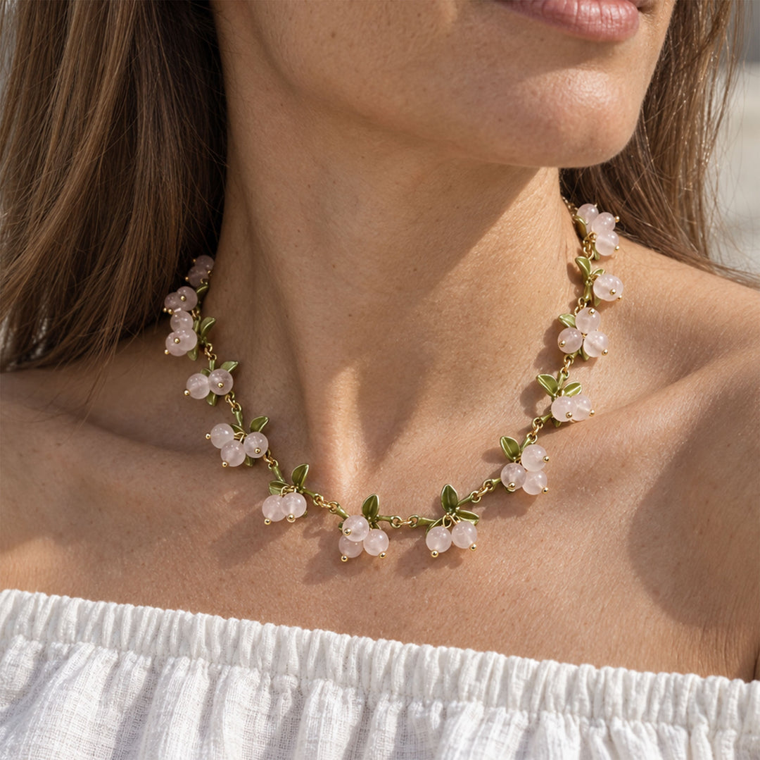 Model wearing Rose Quartz Berry Garden Necklace with hand-painted green enamel leaf details