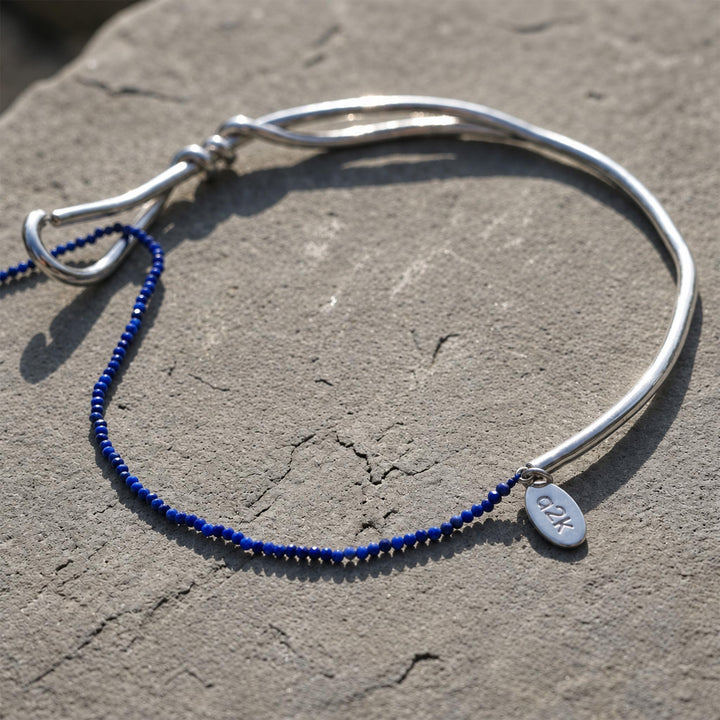 Close-up of silver-plated brass collar with 2 mm faceted lapis lazuli bead strand