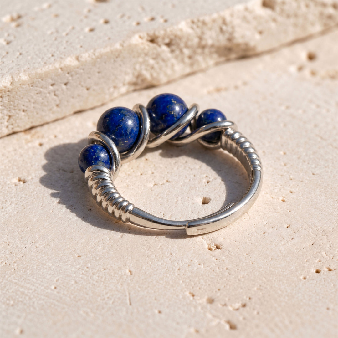 Close-up of 4 mm and 6 mm Lapis Lazuli gemstones in a sculptural platinum-plated 925 silver setting