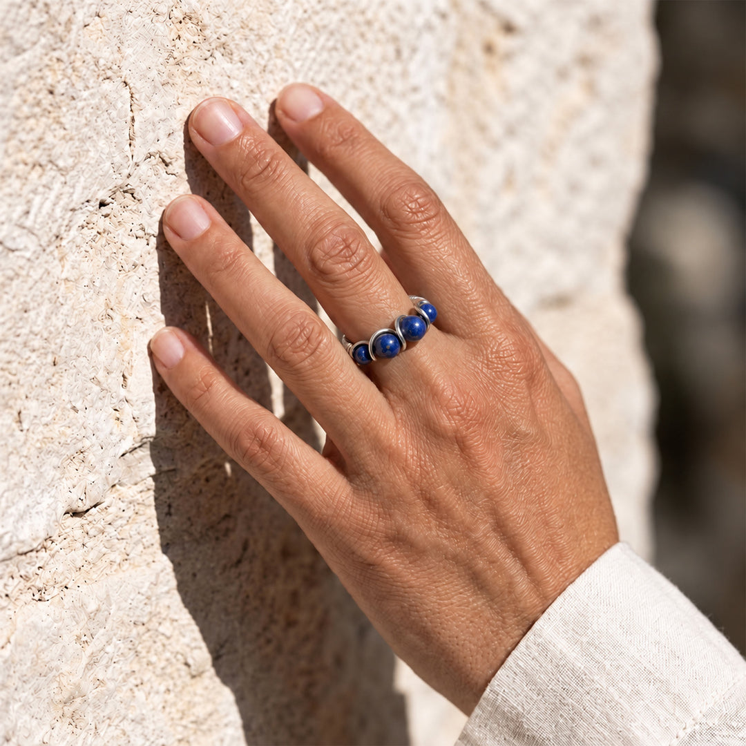 Model wearing Lapis Lazuli adjustable 925 sterling silver ring in natural sunlight