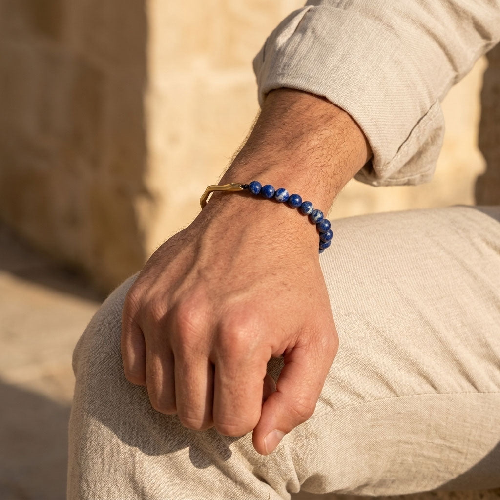 Man wearing lapis lazuli gemstone bracelet with gold stainless steel hook