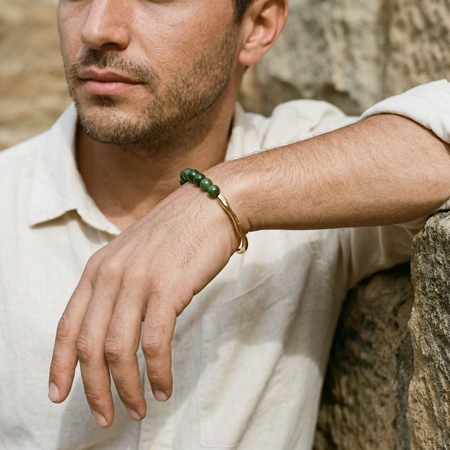 Man wearing minimalist green chalcedony bracelet with gold stainless steel accents