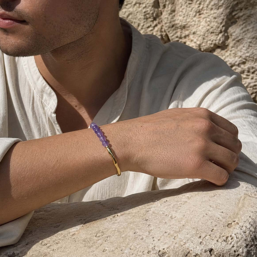 Man wearing amethyst beaded hook bracelet with gold accents