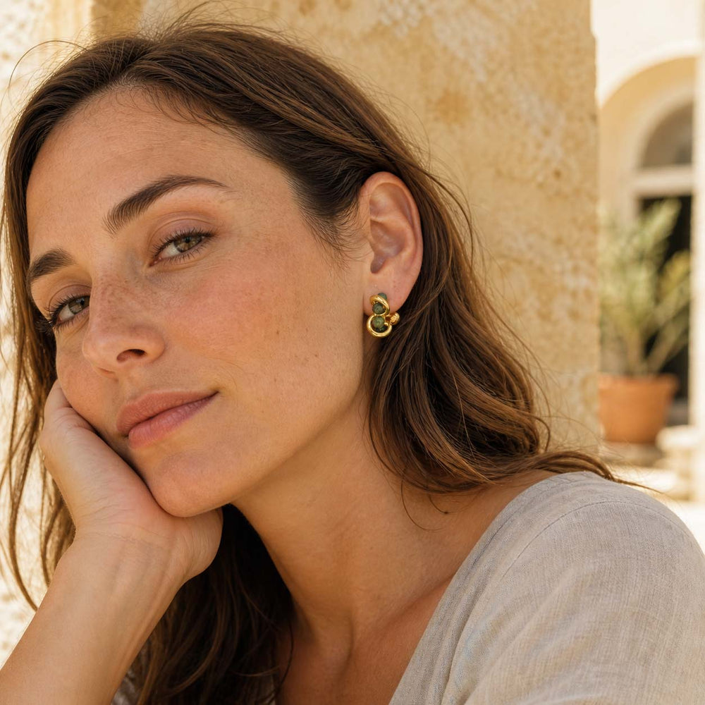 Indian agate sculptural stud earrings worn in warm natural light