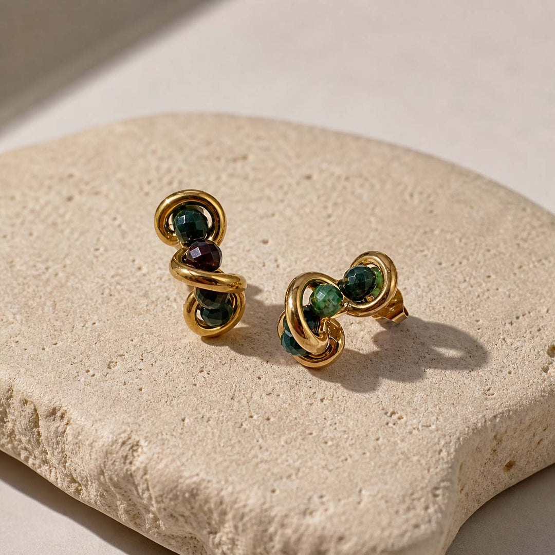 Indian agate gold stud earrings on sunlit textured stone