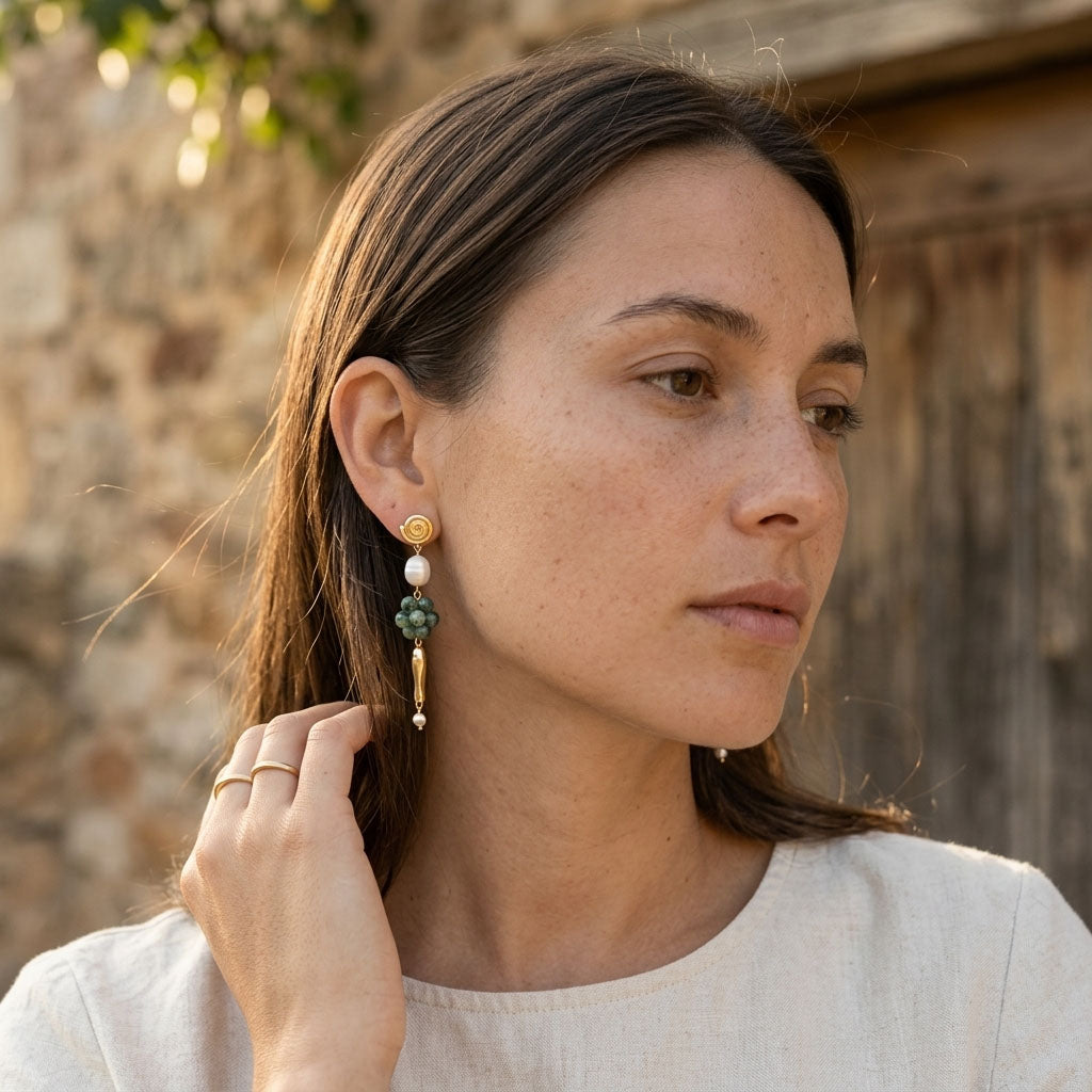 Woman wearing ruby zoisite gemstone drop earrings with pearl accents