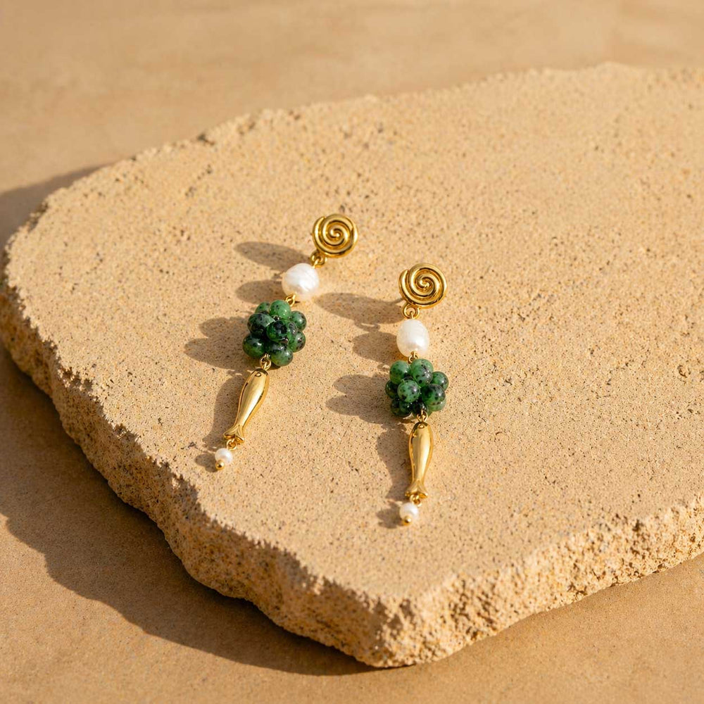 Woman wearing ruby zoisite gemstone drop earrings with pearl accents