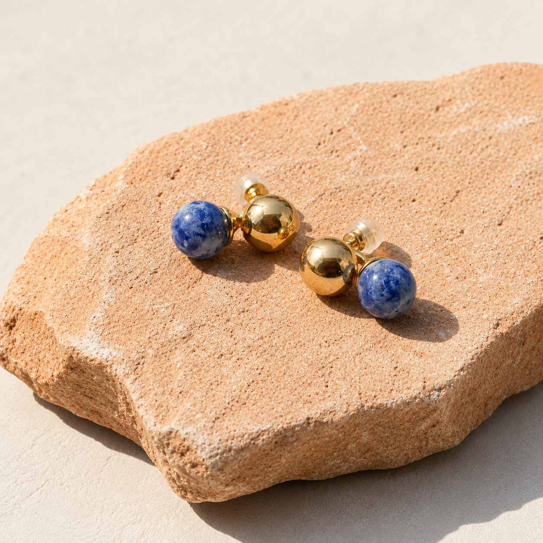 Sodalite sculptural ball earrings on terracotta stone