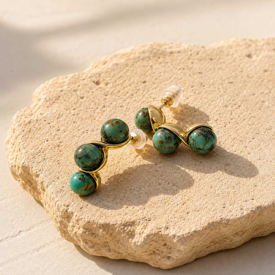 African Turquoise triple bead earrings on sunlit natural stone