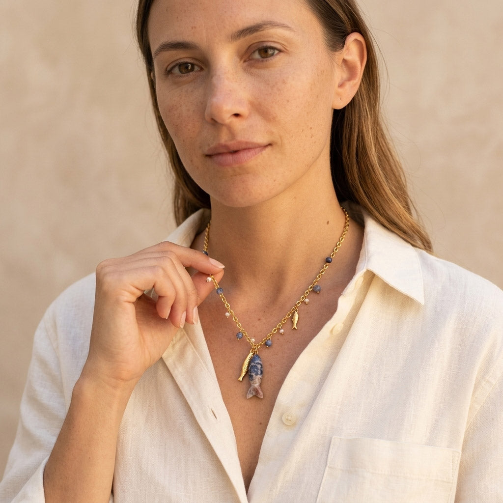 Sodalite fish pendant necklace worn with white linen shirt