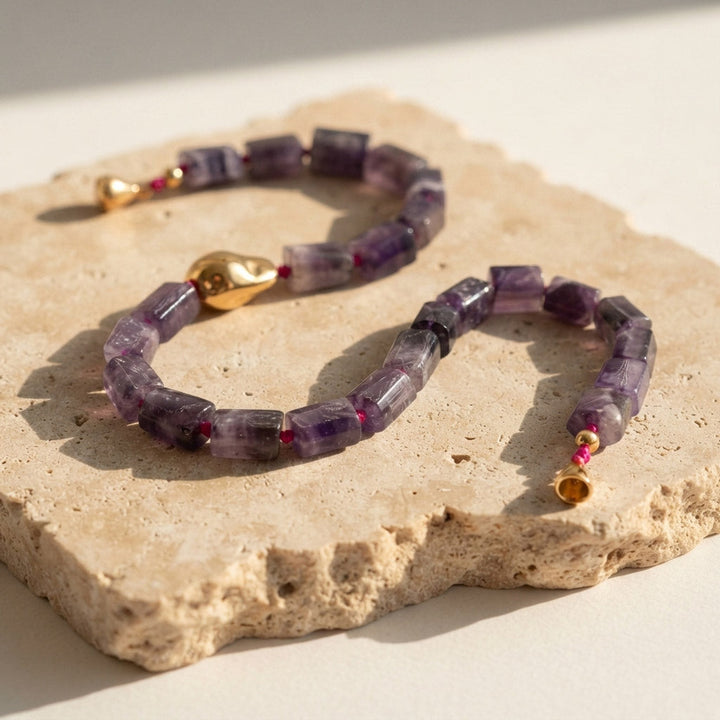 Handcrafted A2K London amethyst sculptural necklace featuring natural 11 × 16 mm amethyst gemstone beads and an organic 18K gold PVD-coated stainless steel accent.